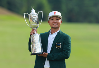 Jinichiro Kozuma holds a trophy