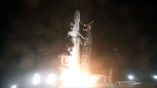 an uncrewed orbital class rocket lifts off into the pitch black sky of an early morning launch