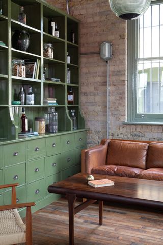 Thames Distillers new home and Fords bar, is an industrial gin brick distillery with a glamorous bar clad in green stone