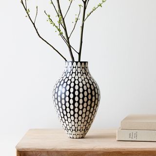 Black and white vase near books