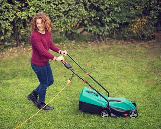 woman mowing a lawn