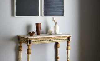Console table with grey painting hanging above it