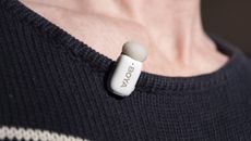 Boya Mini wireless mic clipped to a person's navy sweater