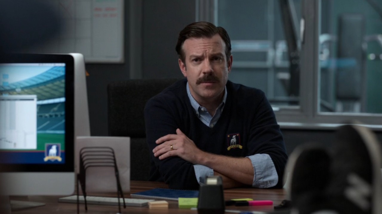 Ted looking concentrated behind his desk.