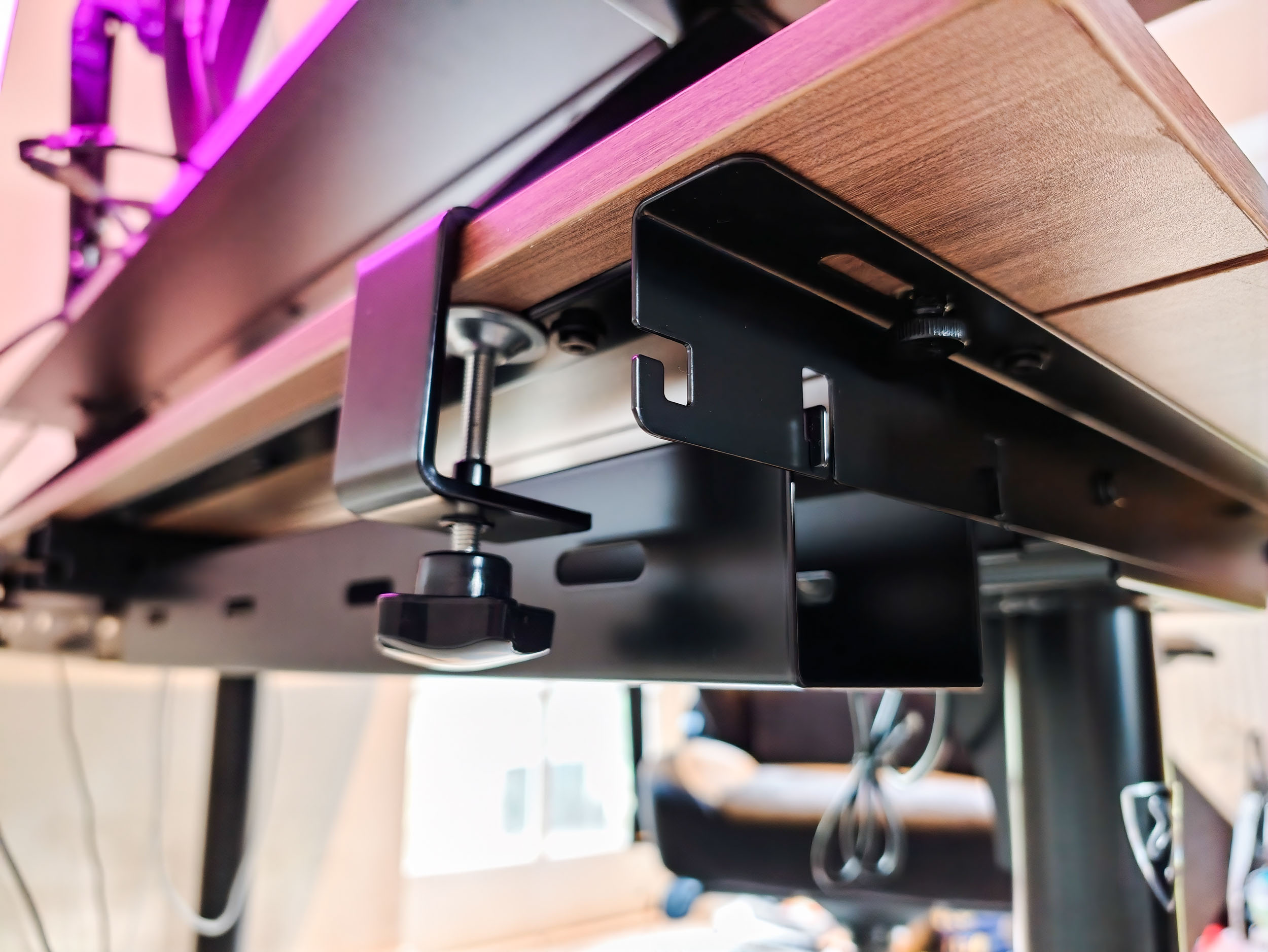 Rear of the Arozzi Arena Nordico Electric Standing Desk, closeup of its cable trays