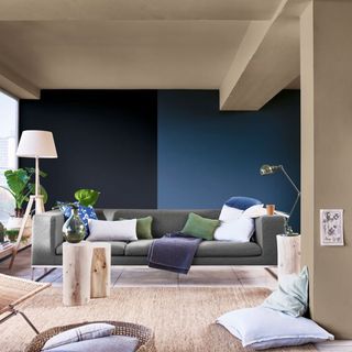 living room with teal blue walls and grey sofa