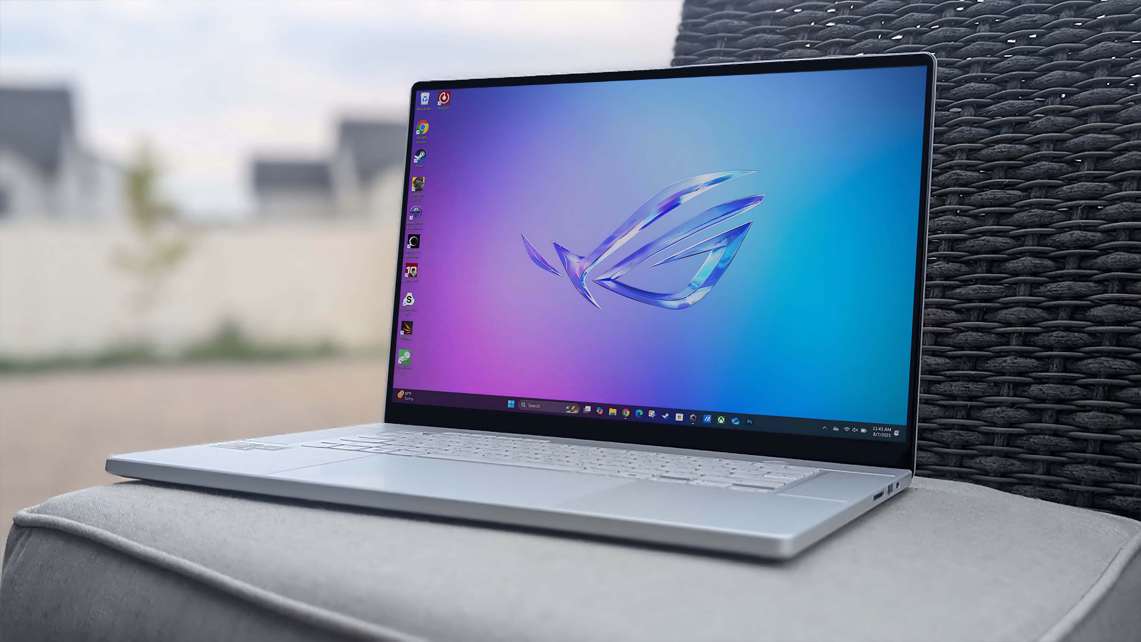 ASUS ROG Zephyrus G16 (GU605C, 2025) outside on a chair.