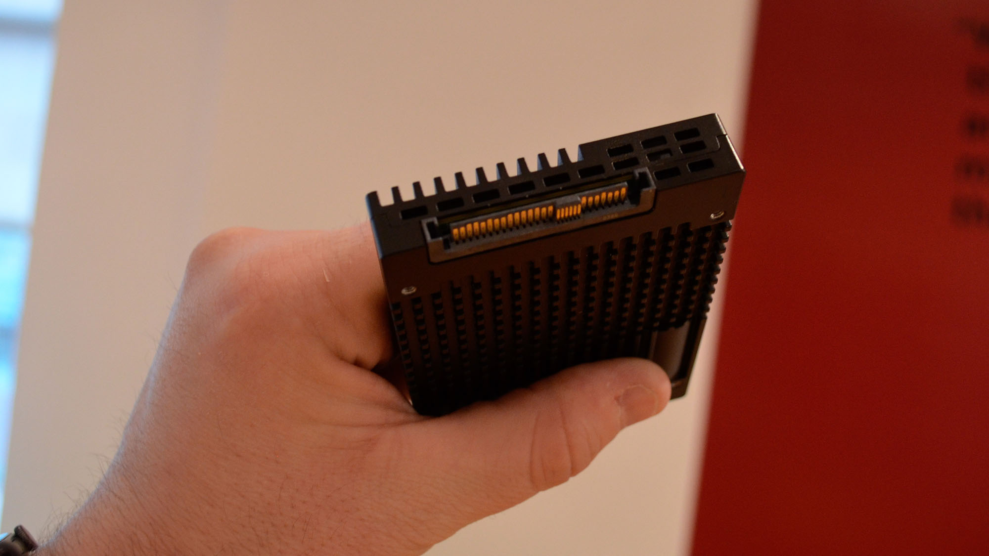 A FlumeIO 5900-series SSD in a masculine hand