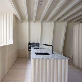 A precise linear arrangement of ceiling joists and cabinetry is seen throughout