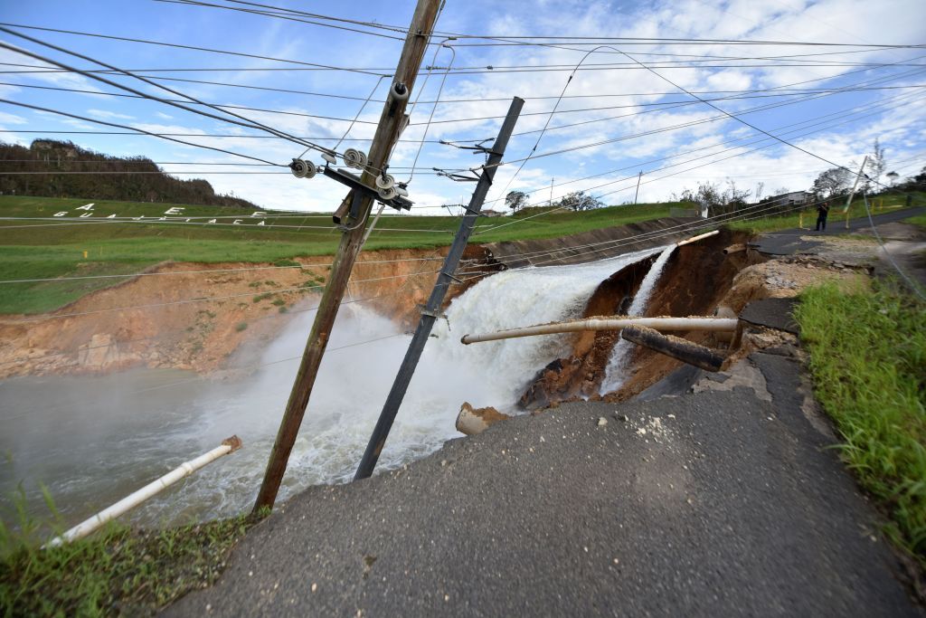 Overflow of a compromised dam in Puerto Rico flooded by Hurricane Maria