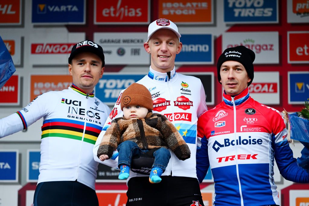OVERIJSE BELGIUM NOVEMBER 20 LR Thomas Pidcock of United Kingdom and Team INEOS Grenadiers on second place race winner Michael Vanthourenhout of Belgium and Team Pauwels Sauzen Bingoal with his child and Lars Van Der Haar of The Netherlands and Team Baloise Trek Lions on third place pose on the podium ceremony after the 62nd UCI Cyclocross World Cup Druivencross Overijse 2022 Mens Elite CXWorldCup Overijse Cyclocross on November 20 2022 in Overijse Belgium Photo by Luc ClaessenGetty Images