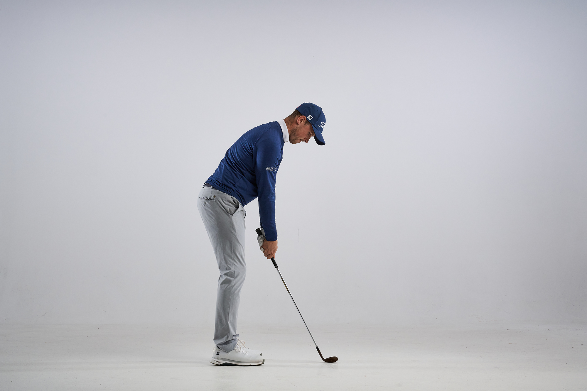 Alex Buckner standing taller at address to promote a posture which prevents chunking chip shots