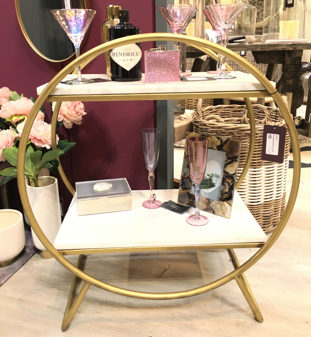 Wine glass with flower in vase and wooden table