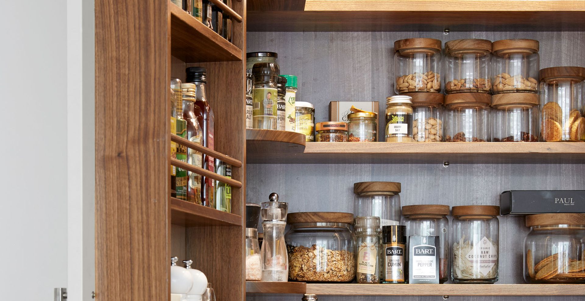 Inside an organized kitchen cabinets showing food stored in glass containers