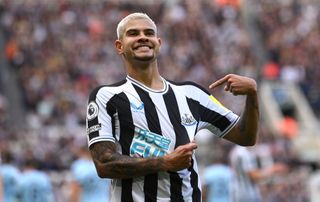 Newcastle United player Bruno Guimaraes celebrates his second goal by pointing to the club badge during the Premier League match between Newcastle United and Brentford FC at St. James Park on October 08, 2022 in Newcastle upon Tyne, England.