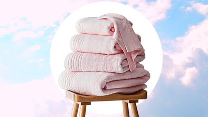 A stack of soft pastel pink towels on a cloud background 