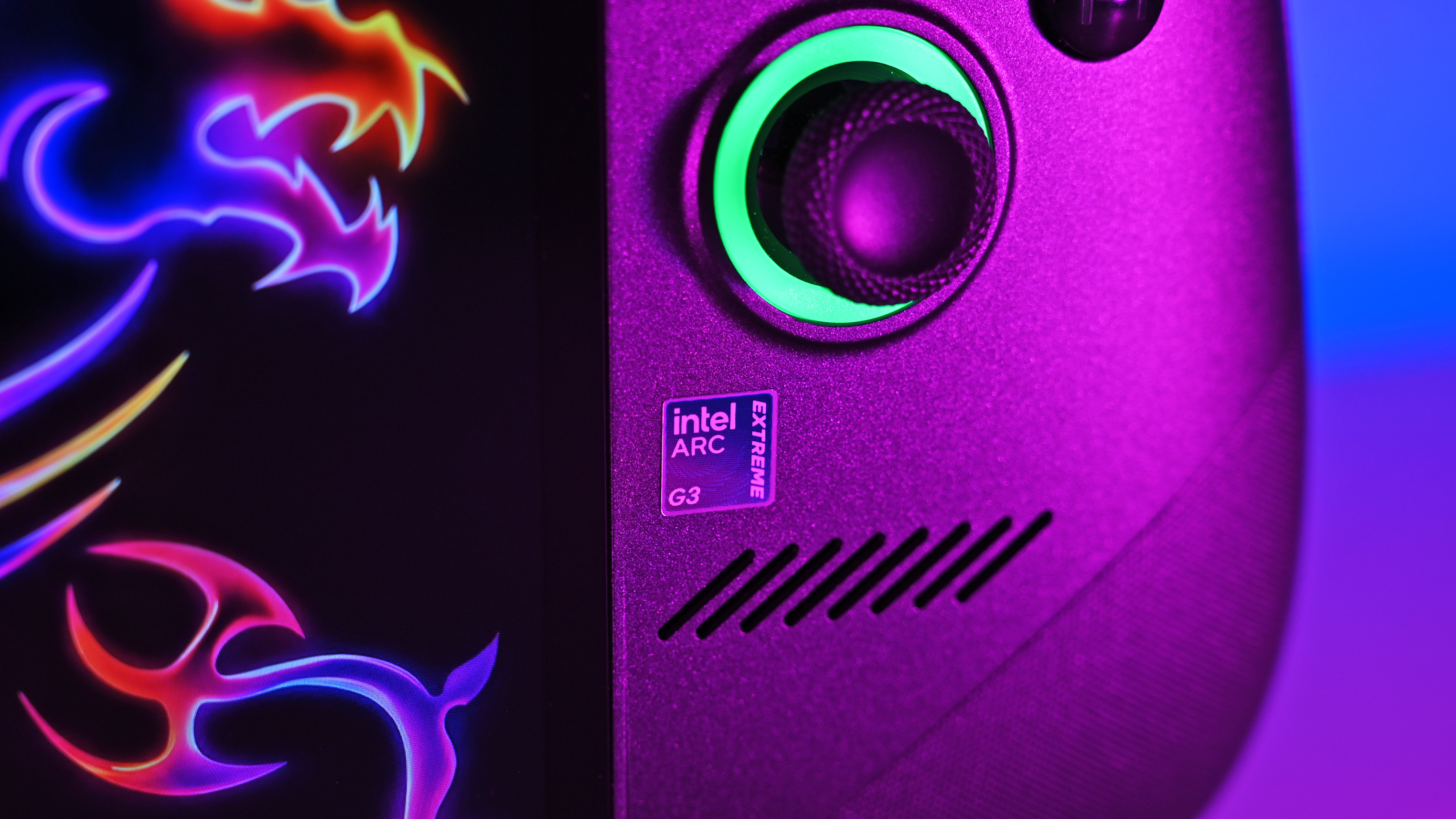 Close-up of the right grip of the MSI Claw 8 EX AI+, highlighting a purple "Intel Arc Extreme G3" holographic sticker badge below the glowing green thumbstick.