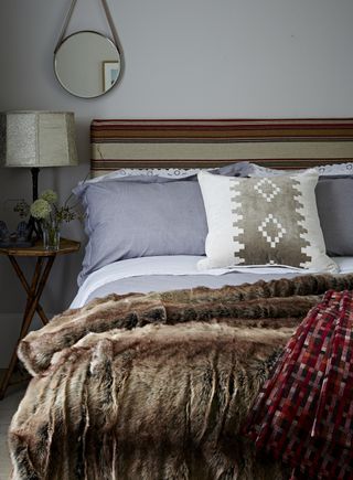 Bedroom with DIY headboard covered in stripe fabric