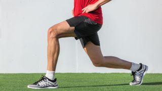 Man doing lunges warming up glute muscles