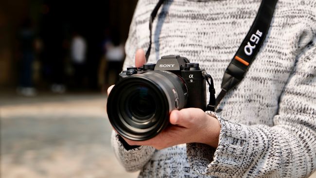 The Sony A9 II being held in two hands
