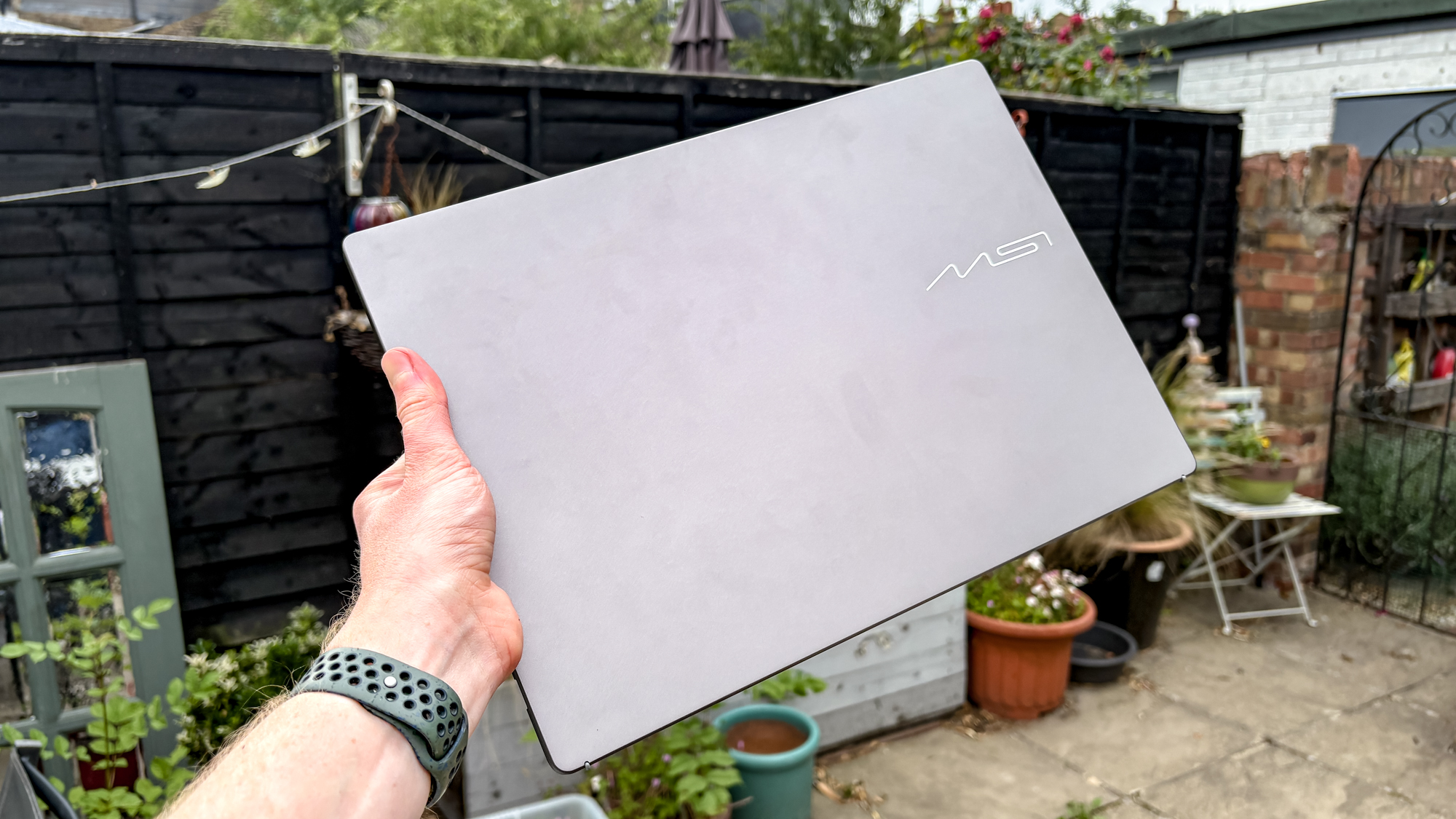 MSI Prestige 16 AI+ closed being held in hand outside