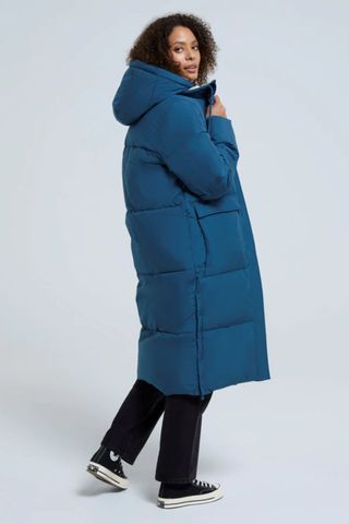 cold weather clothing - woman wearing long padded coat in blue