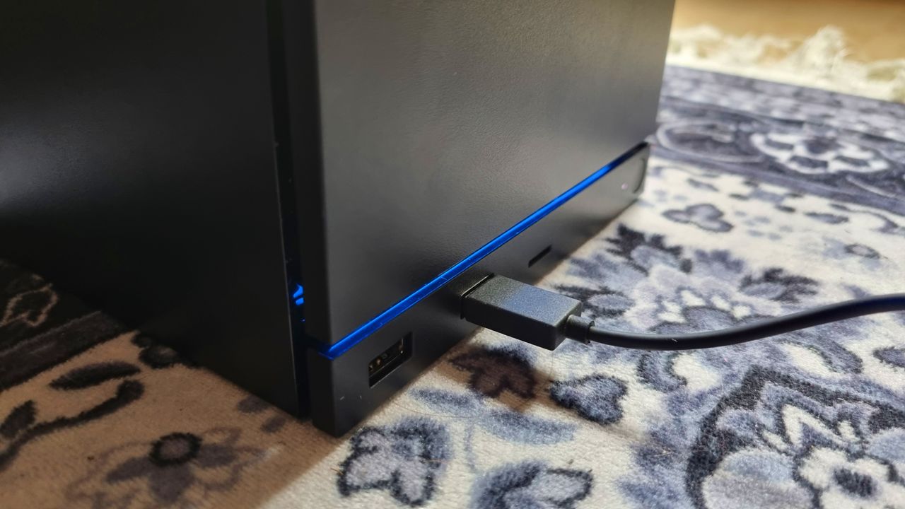 The front I/O panel of the Steam Machine, with a USB Type-A cable plugged into the front