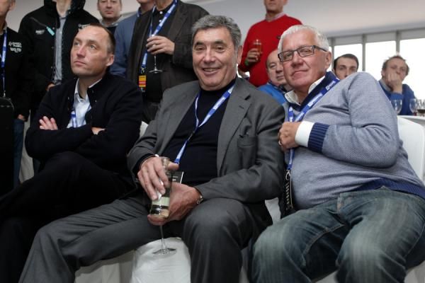 Wouter Vandenhoutte, Eddy Merckx and Patrick Lefevere watch the action on television