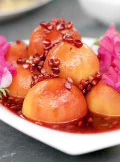 Poached peaches with pomegranate syrup