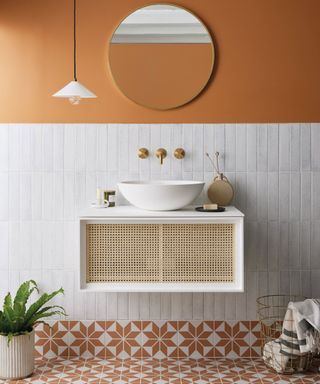 Small bathroom with white tall wall tiles and orange patterned floor tiles
