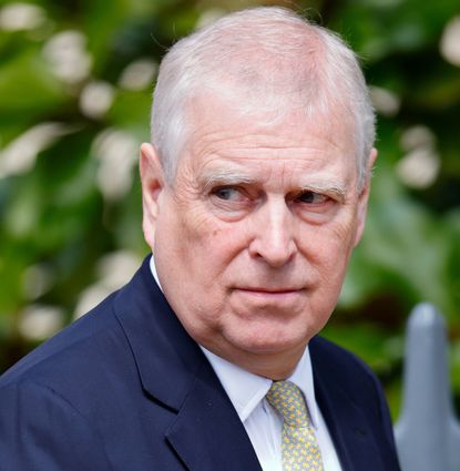 Prince Andrew wearing a blue suit and scowling