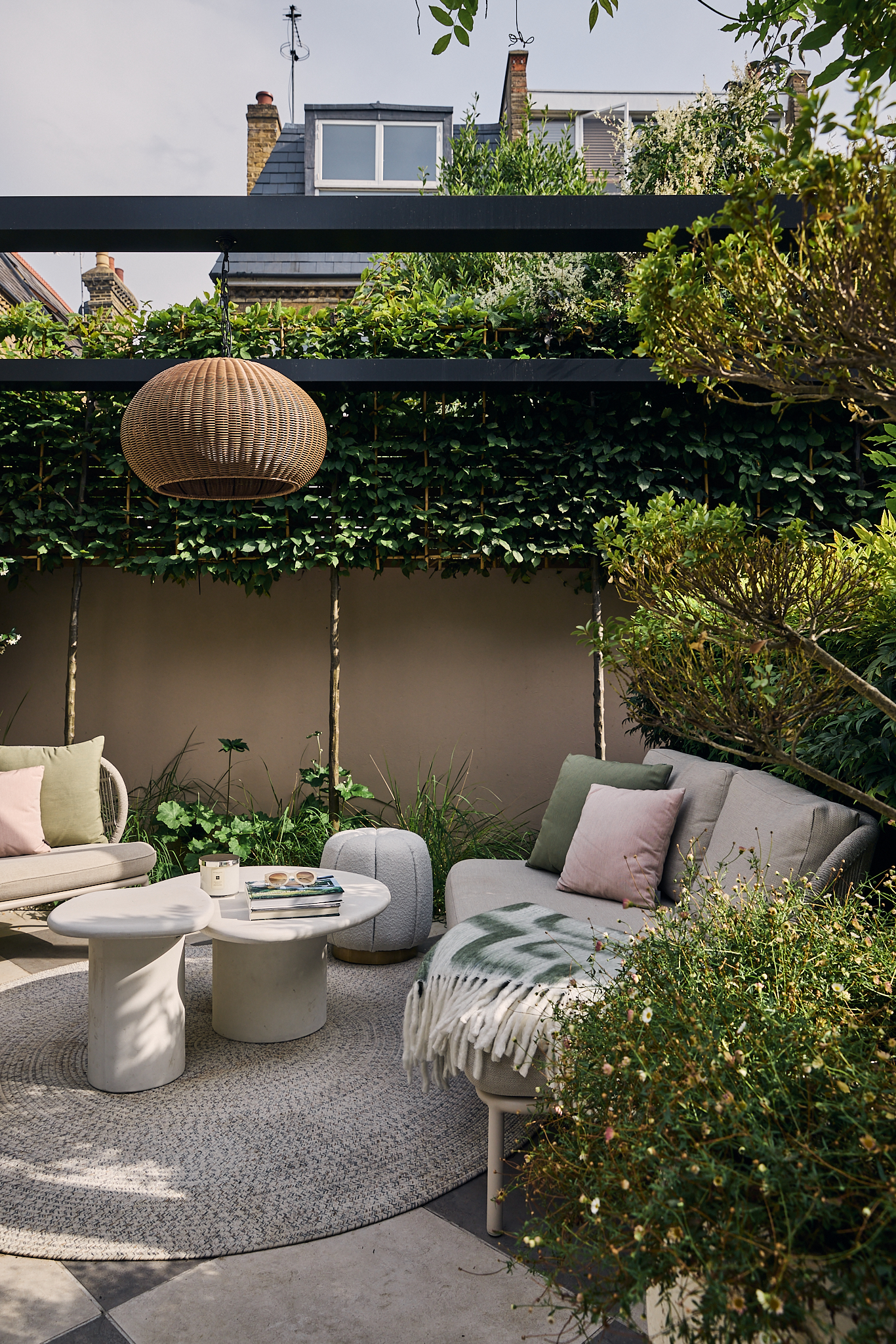 a modern garden filled with plants with a large checkerboard floor