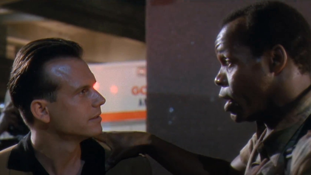 From left to right: Bill Paxton looking at Danny Glover who is looking right back at him.