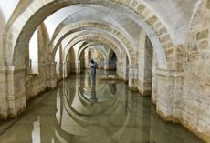 Fig 8: The flooded Crypt of Winchester Cathedral. The Romanesque crypt with Antony Gormley’s Sound II (1986) reflected in the water that regularly floods the space.