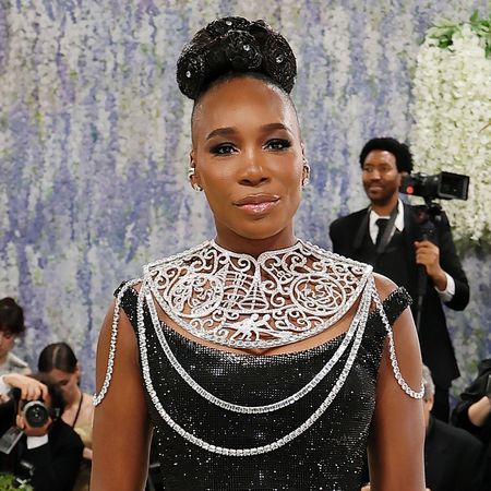Venus Williams with an updo hairstyle wearing a black off-the-shoulder gown and neck plate at the 2026 Met Gala.