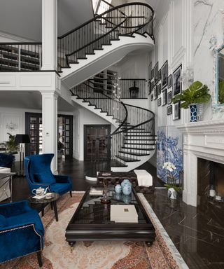 A design project by design firm and studio Bolshakova Interior with black spiral staircase