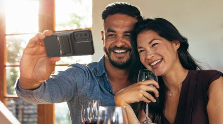 Couple taking a selfie using a phone in a Samsung Galaxy S21 FE case