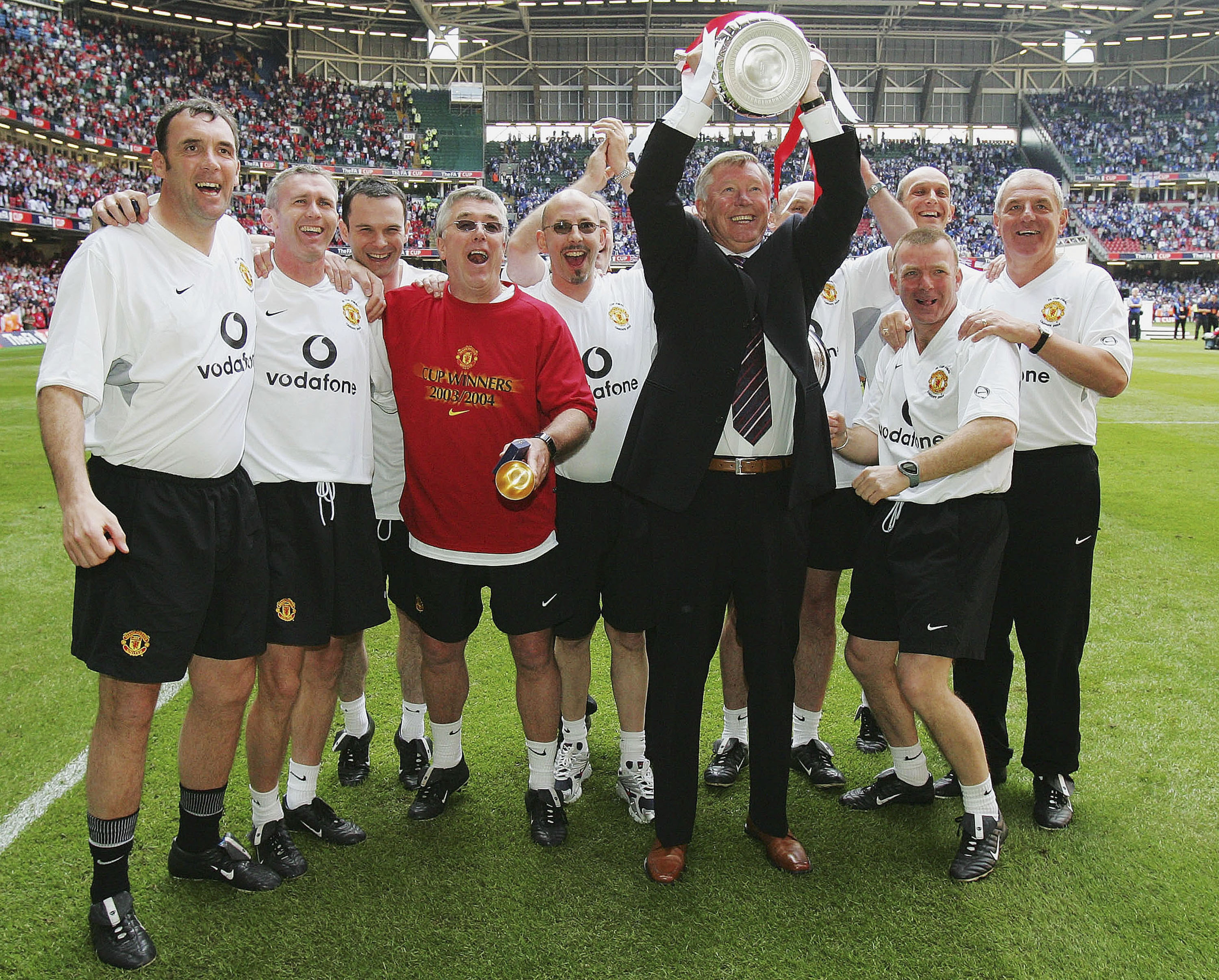 Manchester United manager Alex Ferguson lifts the FA Cup alongside his staff after the Red Devils' win over Millwall in the final in May 2004.