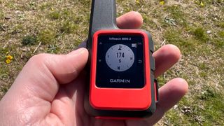 Garmin inReach Mini 2 hiking GPS in someone's hand