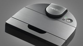 The Neato D10 robot vacuum on a grey background