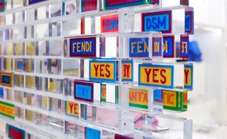 Interior of Fendi pop-up at Dover street market- Bright colours and words written on perspex bricks- 'Yes' 'Fendi' 'DSM' 'Try' and 'Love'