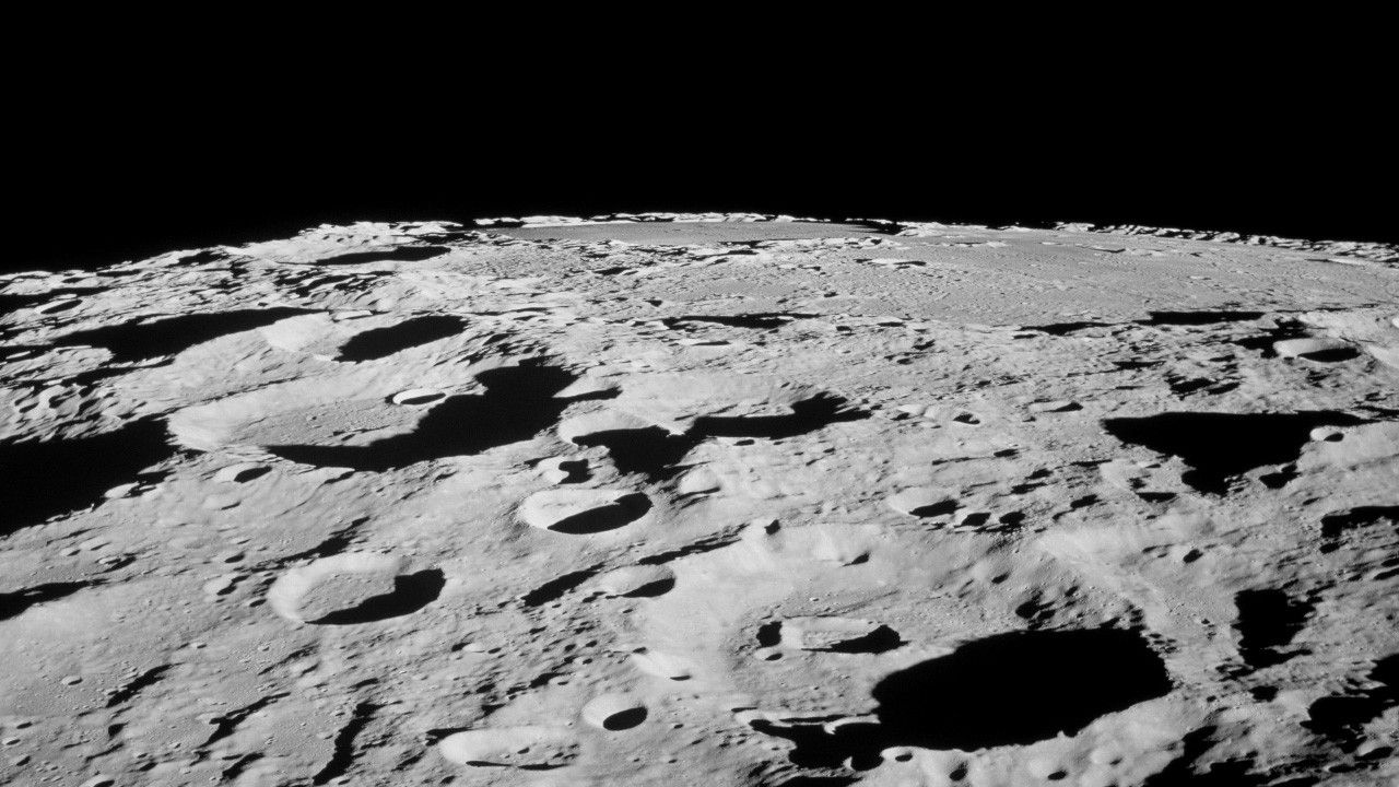 A view of a cratered gray surface.