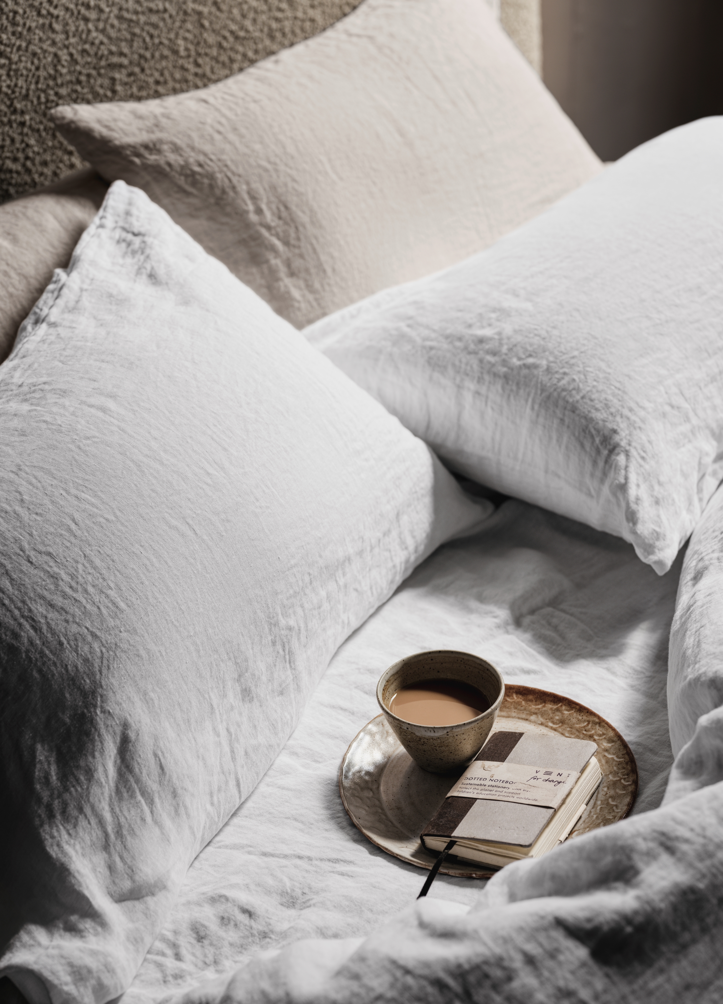 undone linen bedding set with breakfast tray