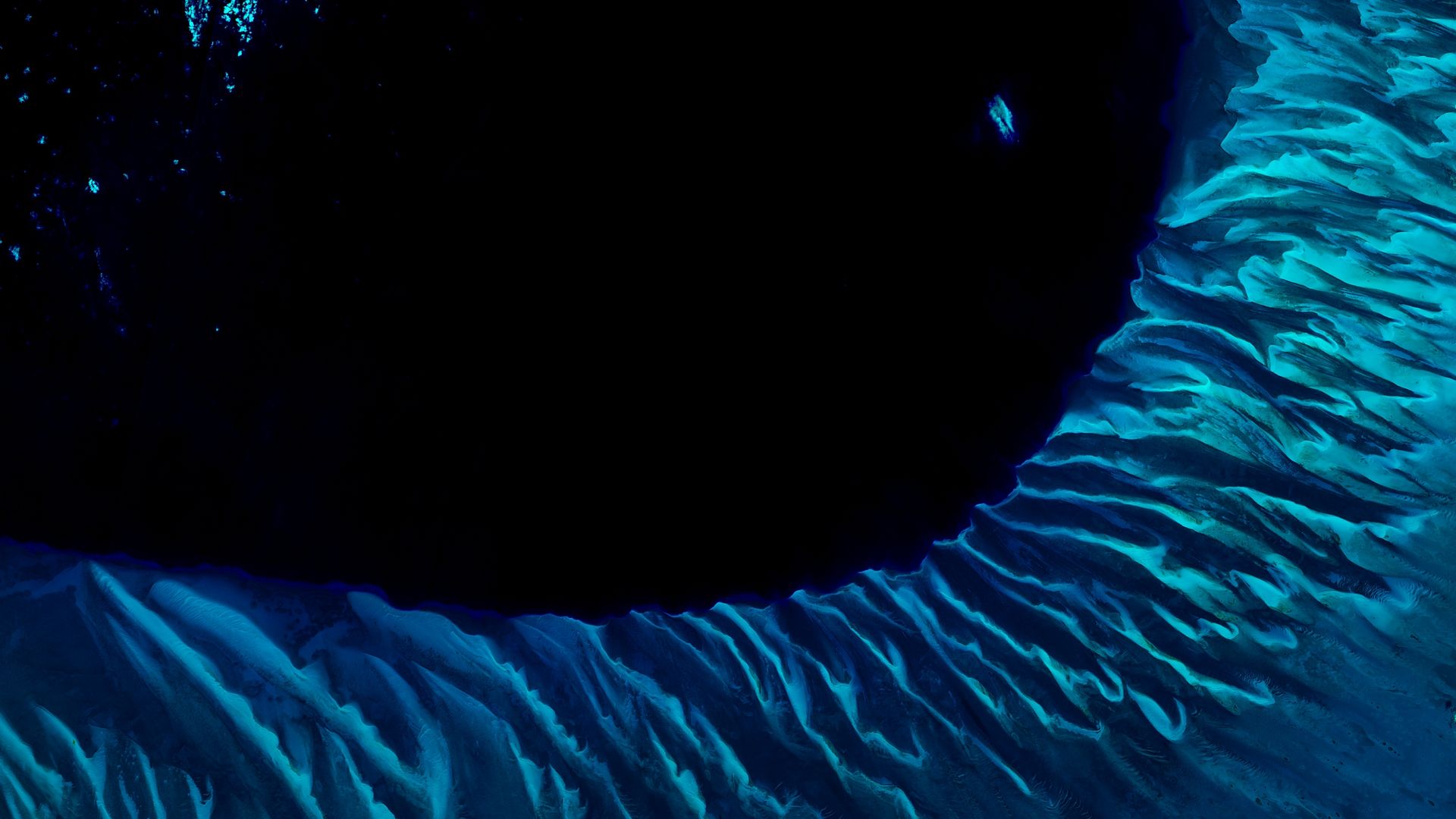 A satellite photo of the Great Bahama bank showing the point where it drops off into the dark