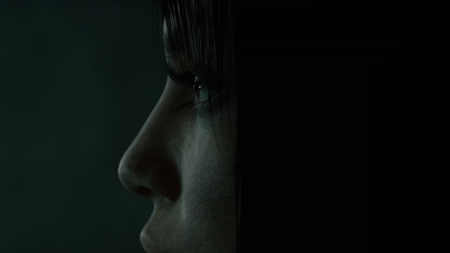 A woman looks off to the side