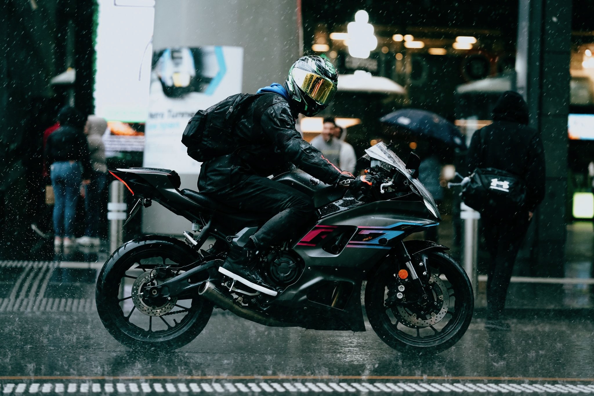 A man on a motorcycle in the rain