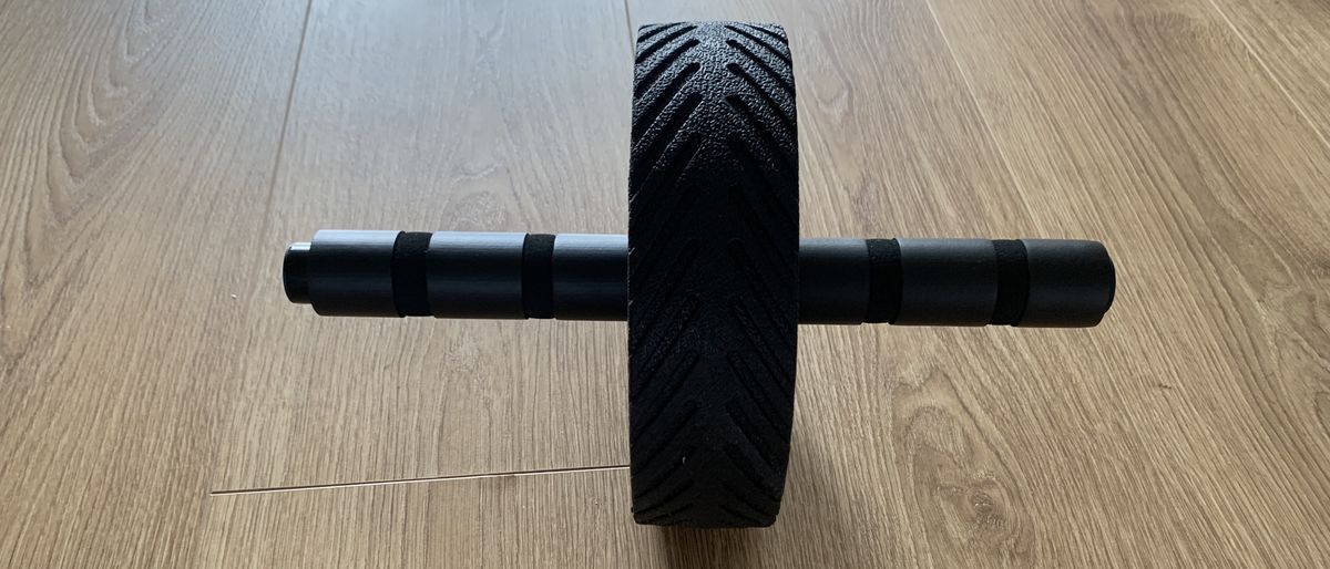 GymShark ab roller on wooden floor