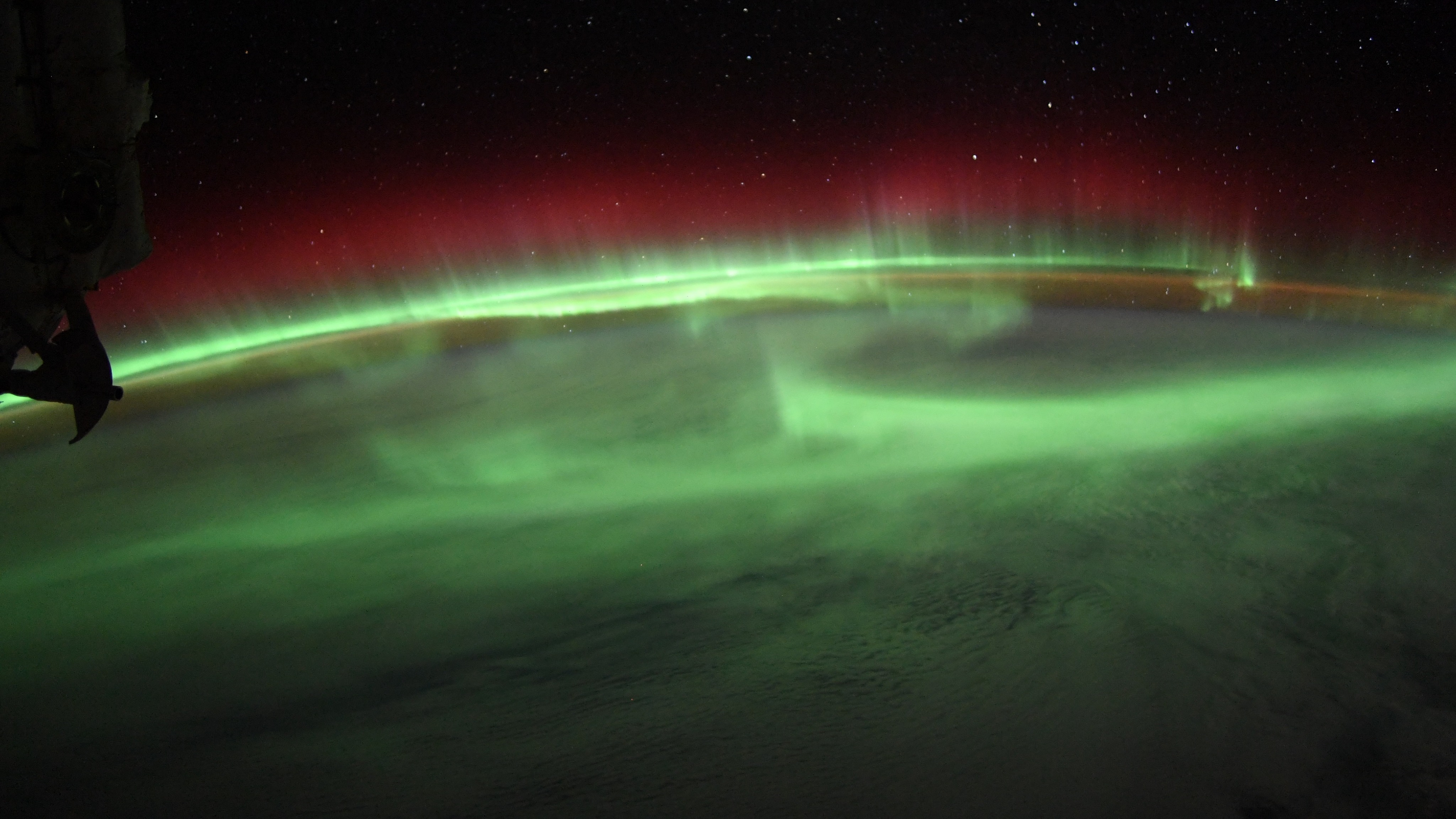 green aurora waves over earth