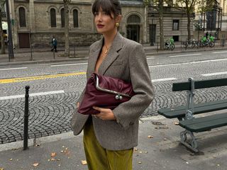 woman in blazer and burgundy bag