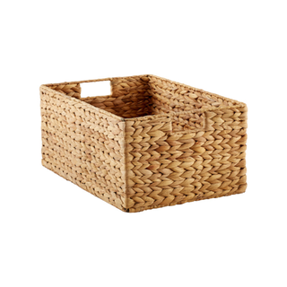 A large woven water hyacinth storage bin with handles